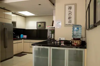 a kitchen with a counter with a bottle of water on it at Villa Kazari Zen in Seminyak