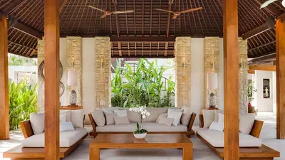 a living room with white couches and a table at Villa The Beji in Canggu