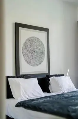 a bedroom with a bed with a picture above it at Villa with 2 Bedrooms & Private Bathrooms near to the beach Seminyak in Seminyak