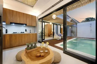 an open kitchen and swimming pool in a house at Summer Cinta Seminyak in Seminyak