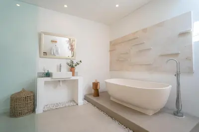 a bathroom with a large white tub in a room at Villa Palma Blanca Canggu by Nagisa Bali in Canggu