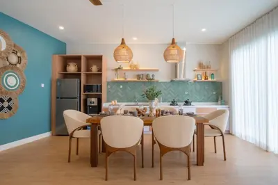 a dining room with a table and chairs at Villa Palma Blanca Canggu by Nagisa Bali in Canggu