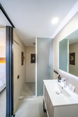 a bathroom with a sink and a shower at Villa Lotus by Unicorn Villas Bali in Kerobokan