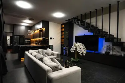 a living room with two couches and a tv at Villa Maya in Kerobokan