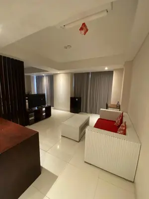 a living room with two couches and a tv at Signature Seminyak in Seminyak