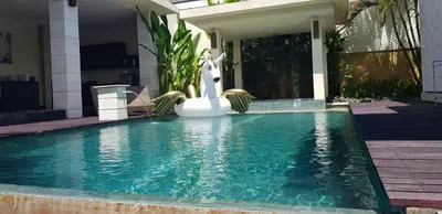 a pool with a statue of a unicorn in a house at Privat Pool Villa with Kitchen at seminyak in Seminyak