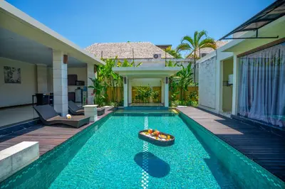 a swimming pool with a boat in the middle of a house at 1BR Private Pool Villa in Seminyak PB in Seminyak