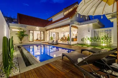 a villa with a swimming pool at night at Harmony Villa Two Bedroom in Canggu
