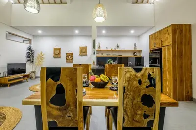 a kitchen with a wooden table with a bowl of fruit on it at Harmony Villa Two Bedroom in Canggu