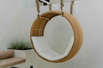 a hanging chair with a mirror in a living room at Villa Madame 3BR Villa Private Pool in Berawa in Canggu