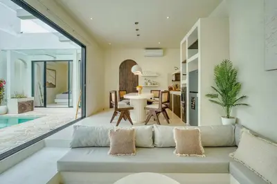 a living room with a couch and a table at Villa Madame 3BR Villa Private Pool in Berawa in Canggu