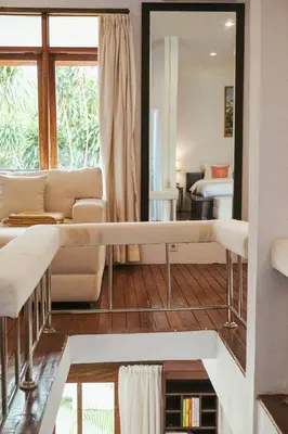 a living room with a couch and a mirror at Villa Frankie in Central Legian in Legian
