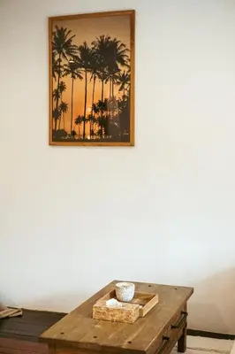 a picture of palm trees on a white wall at Villa Frankie in Central Legian in Legian