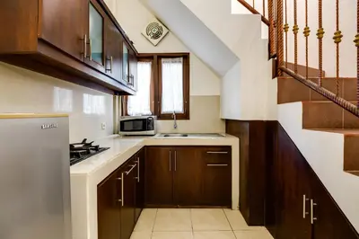 a small kitchen with a sink and a microwave at Gracia Apartment Seminyak Managed by Manara in Seminyak