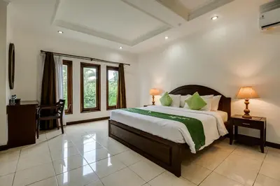 a bedroom with a large bed in a room at Gracia Apartment Seminyak Managed by Manara in Seminyak