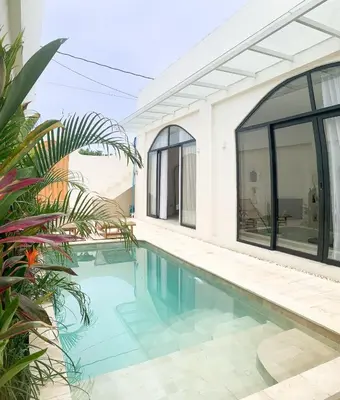 a swimming pool in front of a house at Cozy and Chic Villa with Private Pool at Balangan in Jimbaran