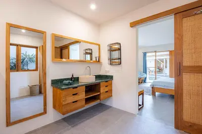 a bathroom with a sink and a mirror at Villa Rice - Amazing Rice-Field VIEW 3BR Villa 9px Next To Canggu in Kerobokan