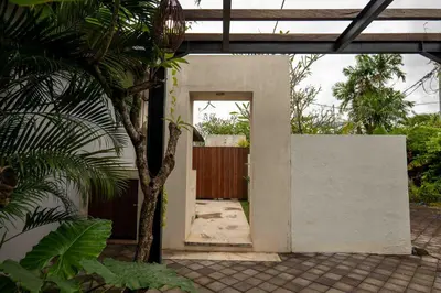 an open door to a house with a fence at Tuluscolivingseminyakvilla1 in Seminyak