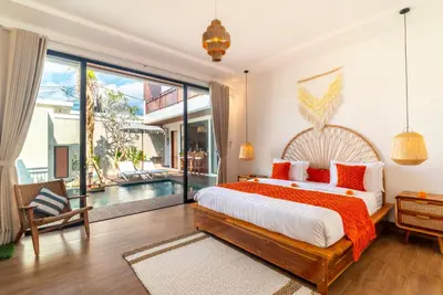 a bedroom with a large bed and a large window at Villa Bella Wilson 4 in Seminyak