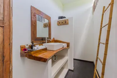 a bathroom with a sink and a mirror on the wall at Villa Ubuntu 3BR Pool Ricefield Family&Friends group near Canggu in Kerobokan