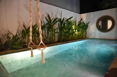 a swing hanging over a swimming pool at Casa Nakoa 2BR With Private Pool in Nusa Dua