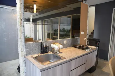 a kitchen with a sink and a large mirror at Casa Nakoa 2BR With Private Pool in Nusa Dua