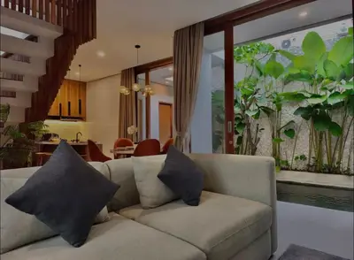 a living room with a couch with two pillows at Villa Mirana in Seminyak