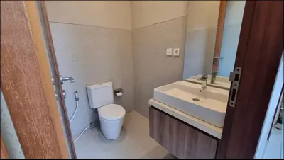 a bathroom with a toilet and a sink and a mirror at Villa Mirana in Seminyak