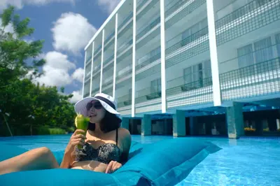 a woman in a swimsuit sitting on an inflatable at The Sintesa Jimbaran Bali in Jimbaran