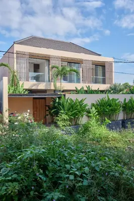 a house with a lot of plants in front of it at Villa Papaya Luxurious4bd Umalas in Canggu