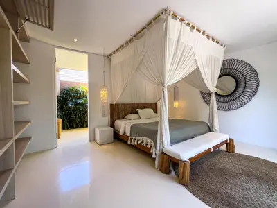 a bedroom with a bed with a canopy at Luxurious 5Br Retreat in Umalas in Canggu