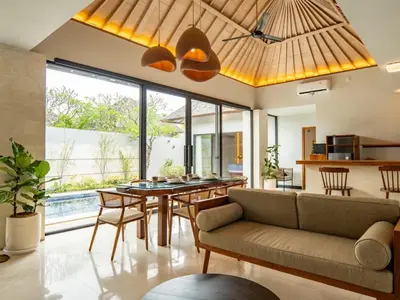 a living room with a couch and a table at tuluscolivingseminyakvilla3 in Seminyak