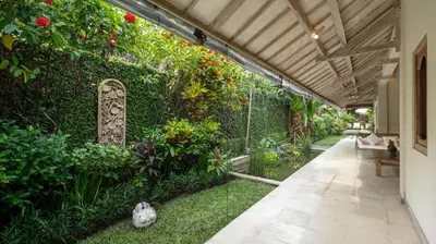 an indoor garden with plants and a walkway at Gembira Villa Seminyak in Canggu