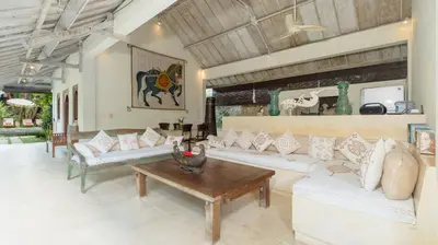 a living room with white couches and a table at Gembira Villa Seminyak in Canggu