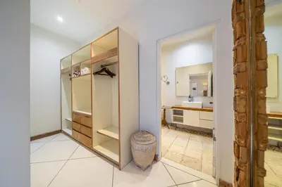 a bathroom with a walk in closet and a mirror at Le Chloe Villa Seminyak in Seminyak