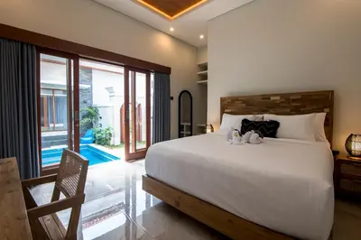 a bedroom with a bed with two stuffed animals on it at Villa Sakura III Seminyak in Seminyak