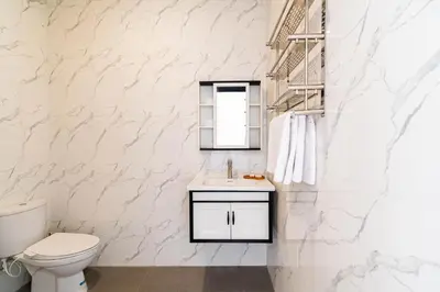a white bathroom with a toilet and a sink at Villa Litan Seminyak - 3 Bedroom Villa in Seminyak