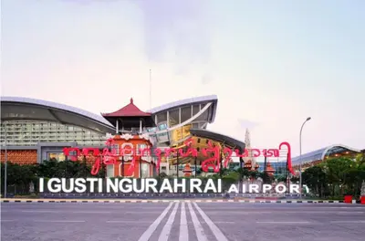 a building with a sign in front of a stadium at RBE Hotel Kuta 2- 5 Min to Airport&Beach by Micky Studio in Ngurah Rai International Airport