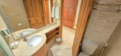 a bathroom with a sink and a toilet and a mirror at The Palmana Courtyard Jayakarta Residence 4 in Seminyak