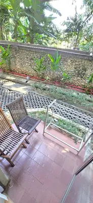 a pair of chairs sitting on a patio at The Palmana Courtyard Jayakarta Residence 6 in Seminyak