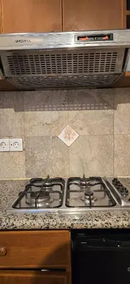 a stove top oven sitting in a kitchen at The Palmana Courtyard Jayakarta Residence 6 in Seminyak