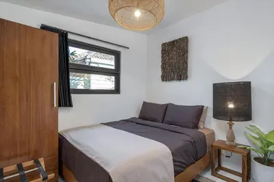 a bedroom with a bed and a window at Incredible Family villa with water slide Beachside in Sanur