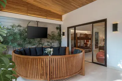 a living room with a couch and a tv at Incredible Family villa with water slide Beachside in Sanur