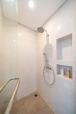 a shower with a glass door in a bathroom at Modern 3BR Villa Private Pool Serangan Beach in Pulau Serangan