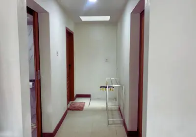 a hallway with a white room with a table at Villa Casanomi By Pandara in Kerobokan