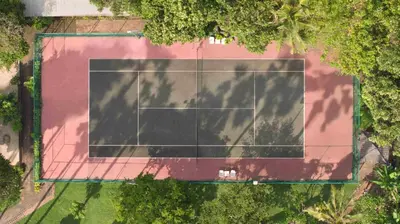 an overhead view of a tennis court with trees at Mana Suites Bali in Kuta