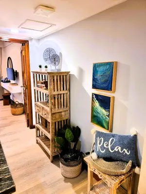 a living room with a chair and a staircase at Mana Suites Bali in Kuta