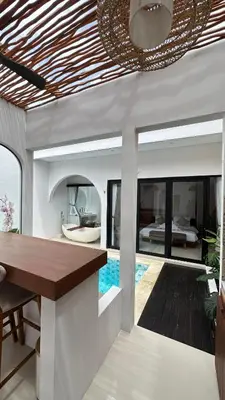 a villa with a swimming pool and a dining room at Maithala Villa & Living in Kuta