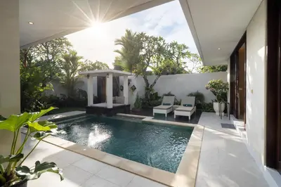a swimming pool in the backyard of a house at Vansari Serenity Villa in Seminyak