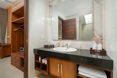 a bathroom with a sink and a mirror at Vansari Serenity Villa in Seminyak